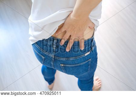 Woman's Hand She Is Caught At The Waist And Her Back Is Painful At The Back In The Park. Cause Of Th