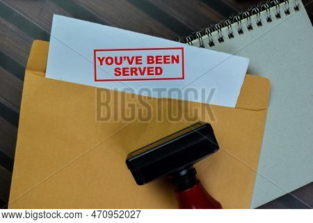 Concept Of Red Handle Rubber Stamper And You've Been Served Text Above From Brown Envelope Isolated 