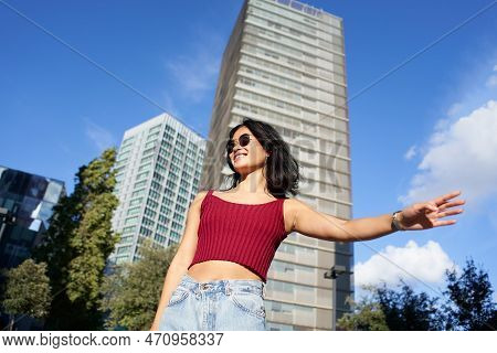 Asian Woman Hailing Taxi Cab Or Ride Share Car Service In The City.