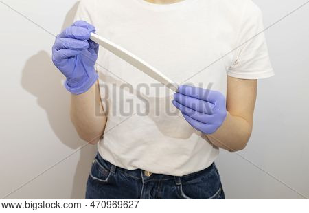 Cropped Caucasian Manicurist, Nail Technician Holds File In Hands, Wearing Gloves. White Manicure Ma