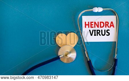 Hendra Virus Symbol. Concept Words Hendra Virus On White Paper Card. Beautiful Blue Table Blue Backg