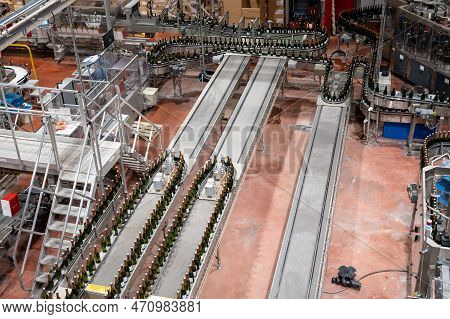Production Of Cremant Sparkling Wine In Burgundy, France. Automatically Powered Bottling Lines On Fa