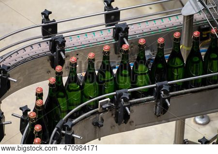 Production Of Cremant Sparkling Wine In Burgundy, France. Automatically Powered Bottling And Corking
