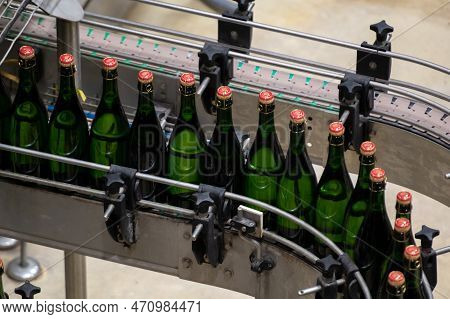 Production Of Cremant Sparkling Wine In Burgundy, France. Automatically Powered Bottling And Corking