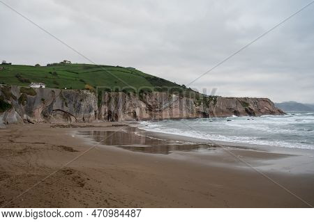 View On Sandy Beach, Rocks And Atlantic Ocean In Zumaia Touristic Ciry, Basque Country, Spain