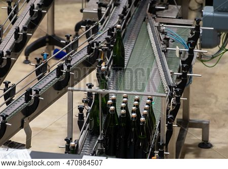 Production Of Cremant Sparkling Wine In Burgundy, France. Automatically Powered Bottling And Riddlin