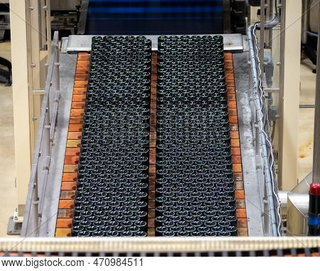 Production Of Cremant Sparkling Wine In Burgundy, France. Automatically Powered Bottling And Riddlin