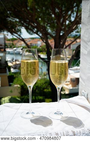 Drinking Of French Brut Champagne Sparkling Wine In Glasses In Yacht Harbour Of Port Grimaud Near Sa