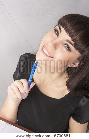 Happy And Positive Brunette Woman Making Notes