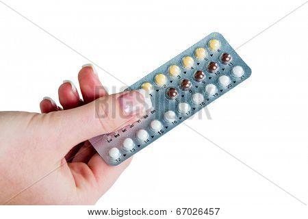 a hand holding birth control pills. symbolic photo for prevention.