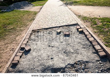 Paving The Footpath With The Tiled Cubes.