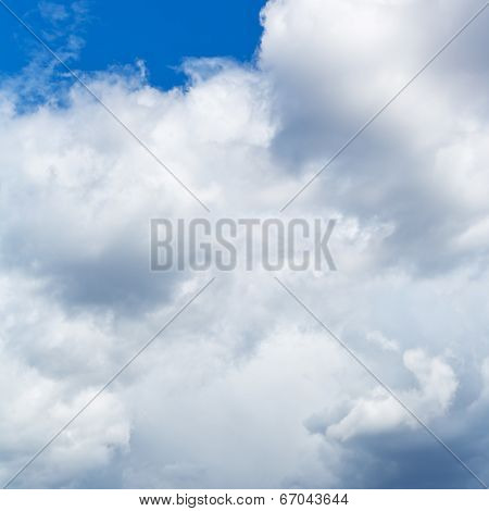 Heavy Cumuli Clouds In Blue Sky