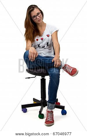 Teenager girl with glasses sitting on chair