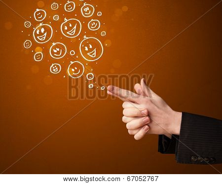 Group of happy hand drawed smiley faces coming out of gun shaped hands