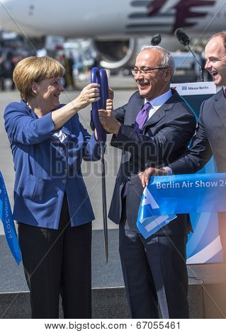 BERLIN, GERMANY - MAY 20, 2014: German Chancellor Angela Merkel, Turkish Minister of transport Lutfi Elvan and CEO Mr Christian (L.-R.) open up the International aviation and space exhibition ILA.