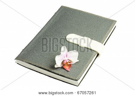 Notebook With Pen And Flower And Orchid