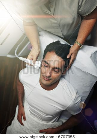 dult man making laser procedure at beauty salon