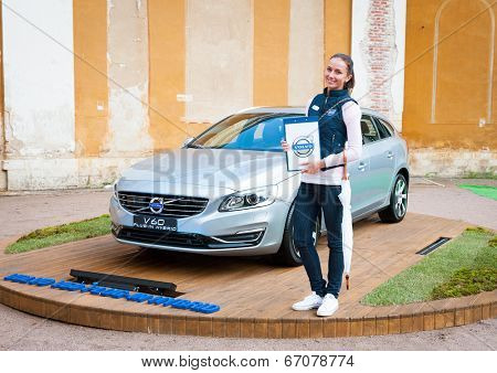 MOSCOW - JUNE 14: Woman presents Volvo hybrid car v60 model at open-air concert on XI International Jazz Festival 