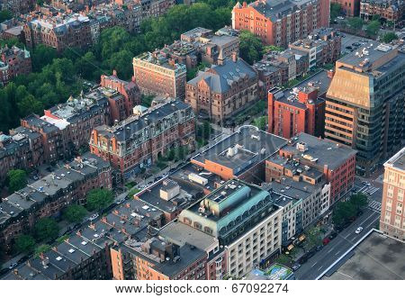 Boston city downtown aerial view with urban historical buildings at sunset.