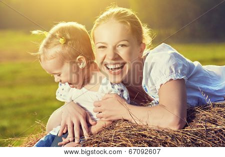 Happy Family In Summer Nature. Mother And Baby Daughter In The Hay, Straw