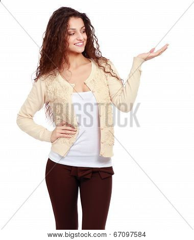 portrait of pretty happy young woman pointing at copyspace, isolated on white background