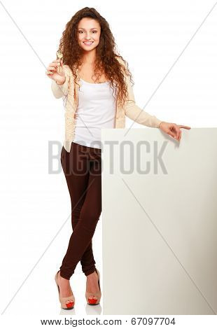 Portrait of a  young woman holding blank card and key- over white background.