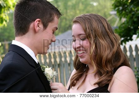 Laughing Prom Girl Fixing Boutonniere