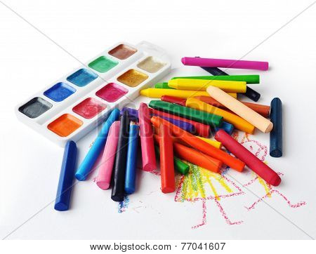 Watercolours And Heap Of Colourfull Crayons On White Background