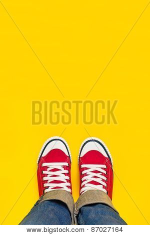 Feet From Above, Teenager In Sneakers Standing On Yellow Background