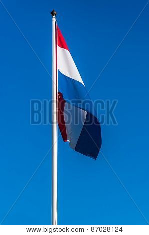 Netherlands Flag On The Blue Sky