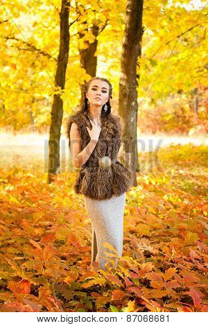 Beautiful woman over autumn leaves
