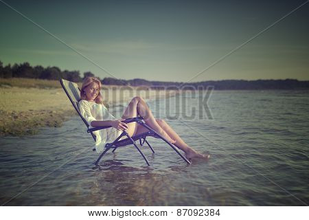 young woman in sexy swimsuit relaxing on the beach