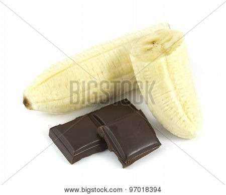 Sliced and peeled banana with chocolate pieces isolated on white background