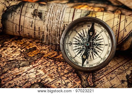 Travel geography navigation concept background - old vintage retro compass on ancient world map