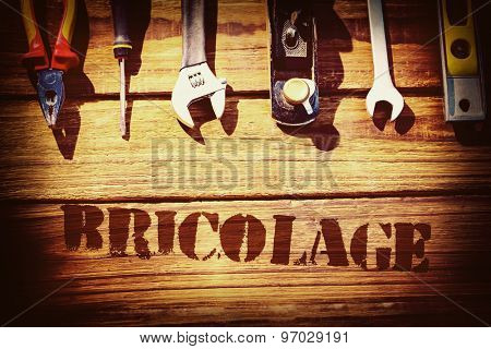 The word bricolage against desk with tools