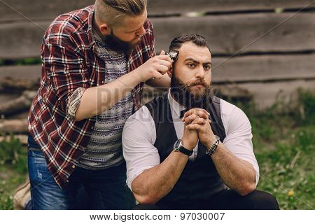 two bearded men shave