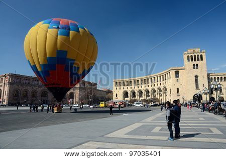People launching colorful hot air balloon near the Government building on Republic square,Erevan