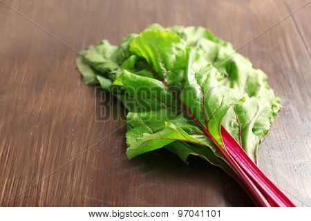 Fresh swiss chard on wooden table, close up