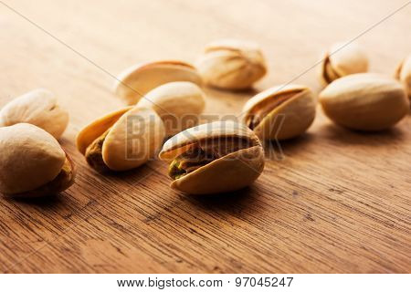 Pistachio nuts with shell on a old kitchen table.