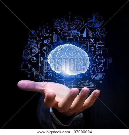 Close up of businessman hand holding brain in palm