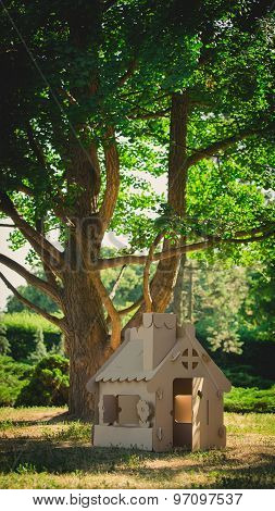 Toy house made of corrugated cardboard in the city park