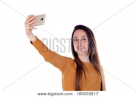 Teenager girl taking a selfie with her mobile isolated on a white background