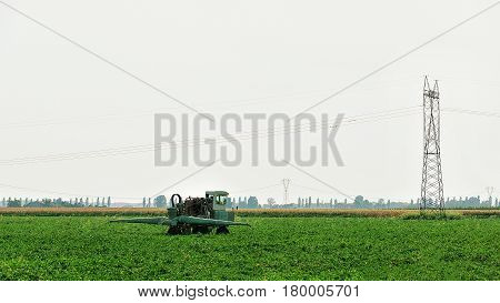 Tractor With Plough Doing Some Seasonal Agricultural Work In Field