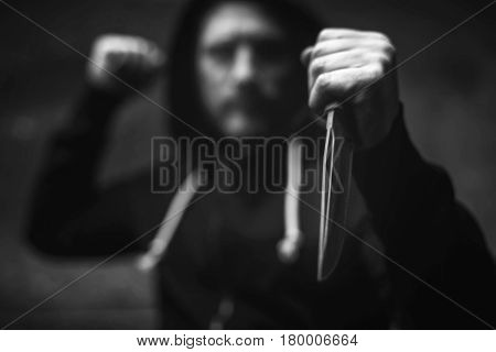 One stab to take your life. Attacking destructive heated villain trying getting his victim scared while threatening her with a dagger