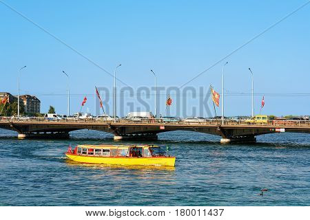 Excursion Ferry In Geneva Lake And Bergues Bridge With Flags
