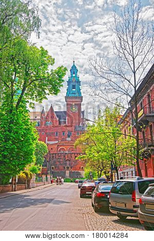 Bell tower of Wawel Cathedral on the hill and people at the city center Krakow Poland.