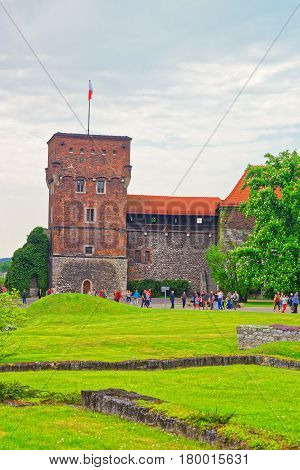 Krakow Poland - May 1 2014: Tower and courtyard of Wawel Castle and people around in Krakow Poland