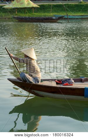 Hoi An Vietnam - February 20 2017 - The boatwoman  on the old national vietnamese boat down the Thu Bong river.