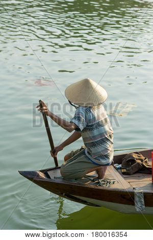 Hoi An Vietnam - February 20 2017 - The boatwoman  on the old national vietnamese boat down the Thu Bong river.