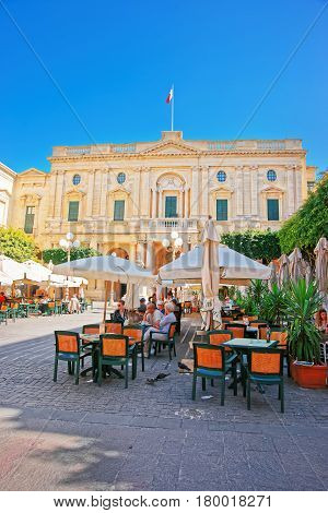 People Resting At Open Air Cafes In Republic Square Valletta